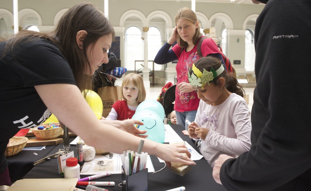 A girl doing craft activities at one of the stalls