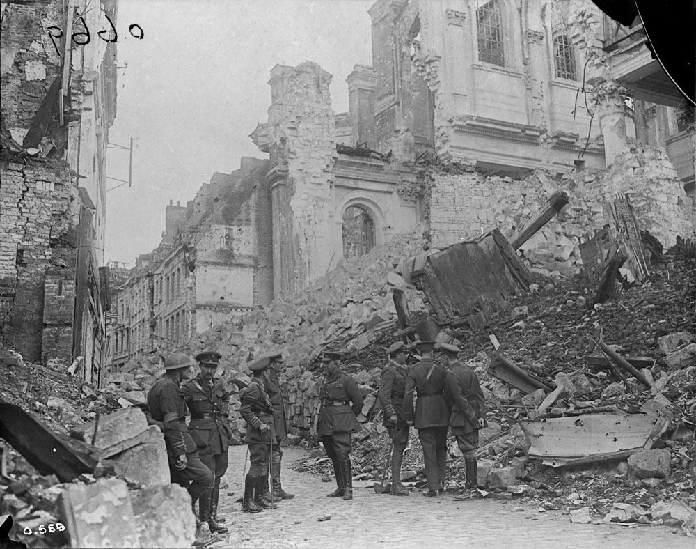 The same group of Canadian officers inspecting the rubble on Rue Méaulens