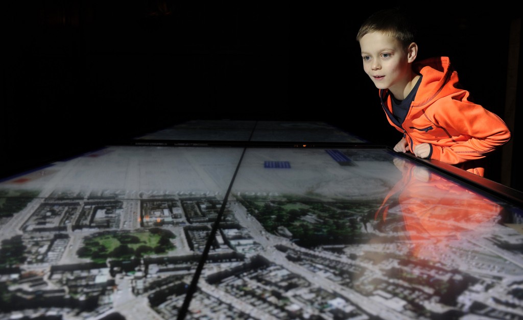 A young visitor explores the stories of Edinburgh and Nanjing in A Tale of Two Cities exhibition at Edinburgh Castle in December 2015