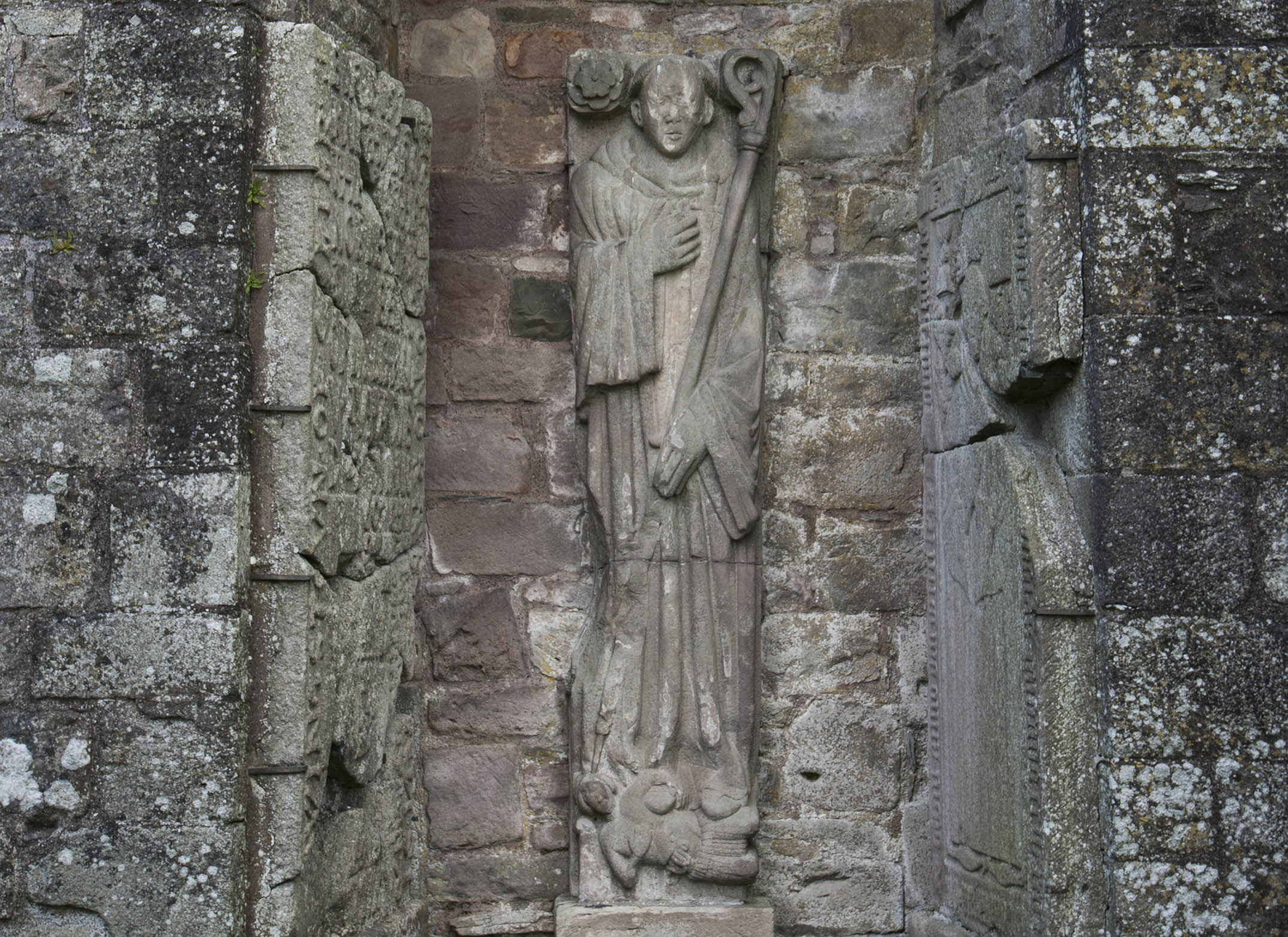 Effigy of an unknown abbot of Dundrennan. The dagger at his haert, along wih the partly disembowelled figure at his geet, has been taken to suggest that this abbot was murdered.
