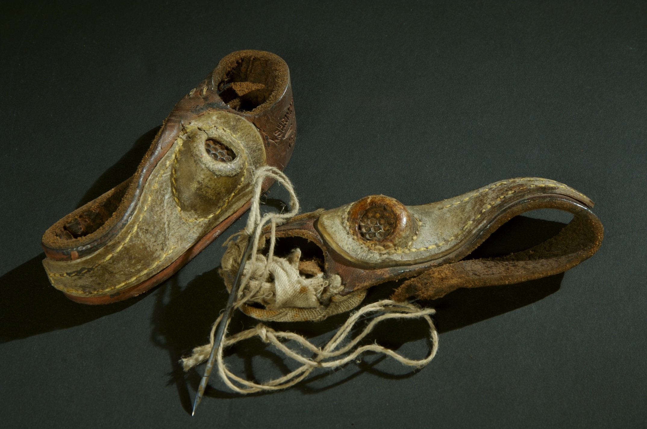 Un-matched pair of Sailmaker's palms made from leather and canvas.