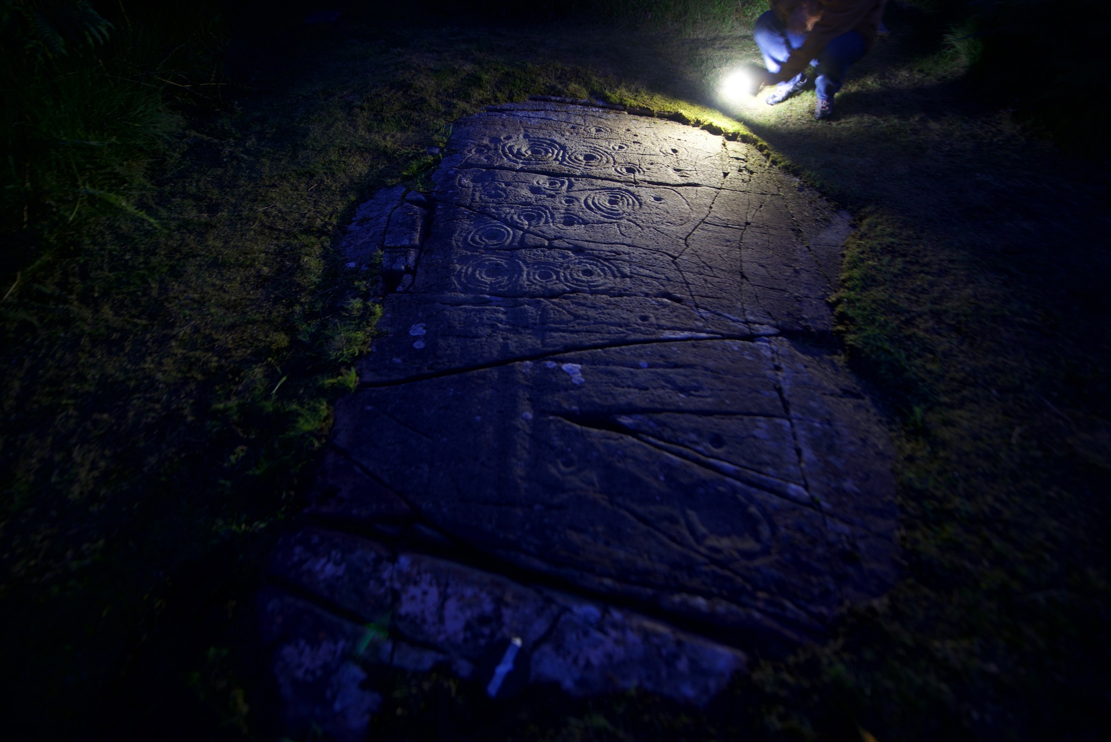 Cairnbaan rock marks in torch light