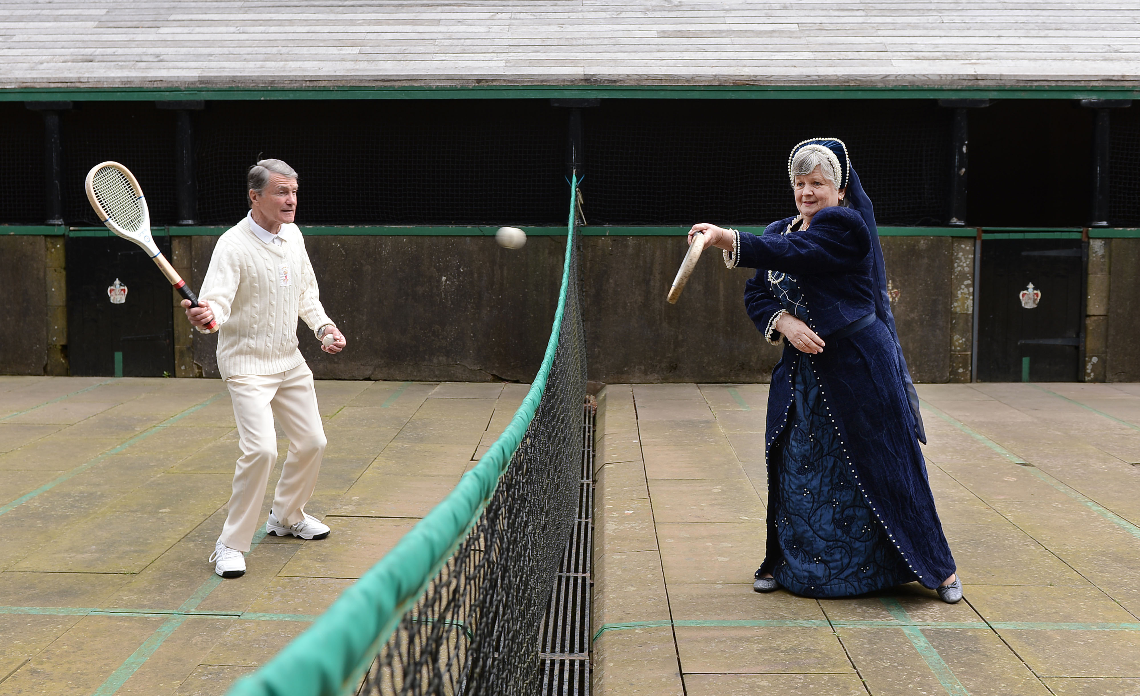 Two costumed characters playing tennis
