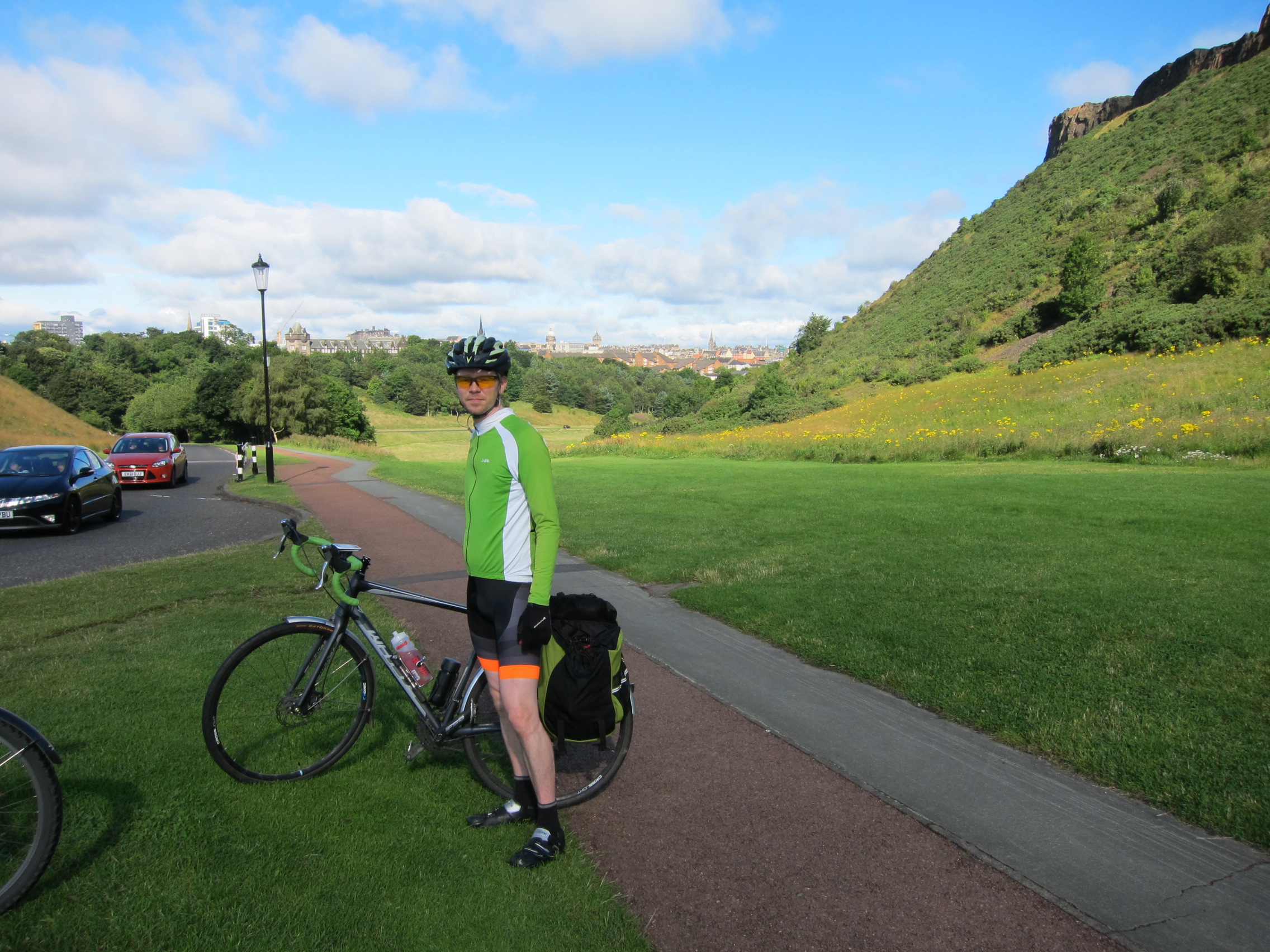 Gareth in cycle gear standing next to his bike in Holyrood Park