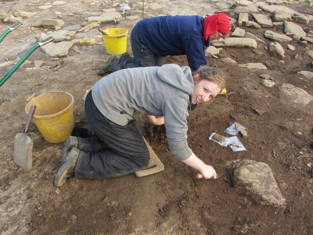 Two archaeologists working on an excavation site at the Links of Noltland