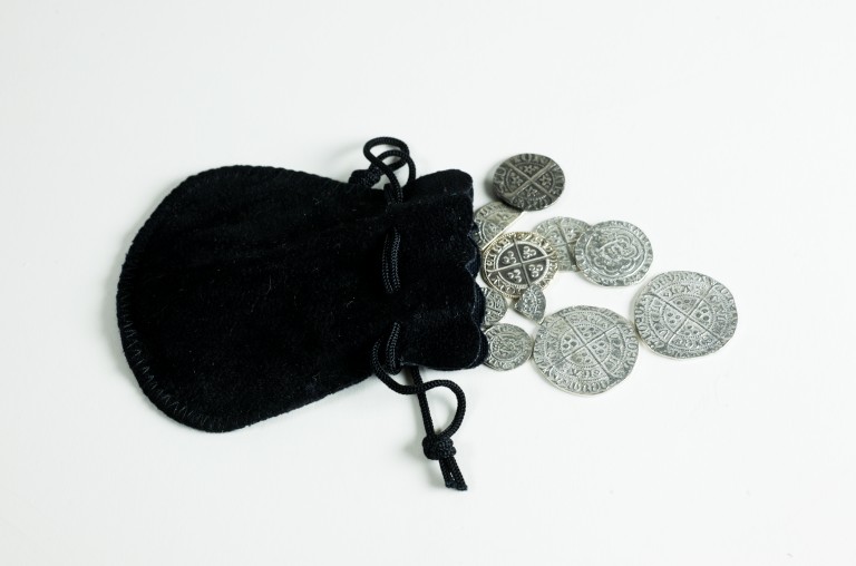 A black purse containing silver coins