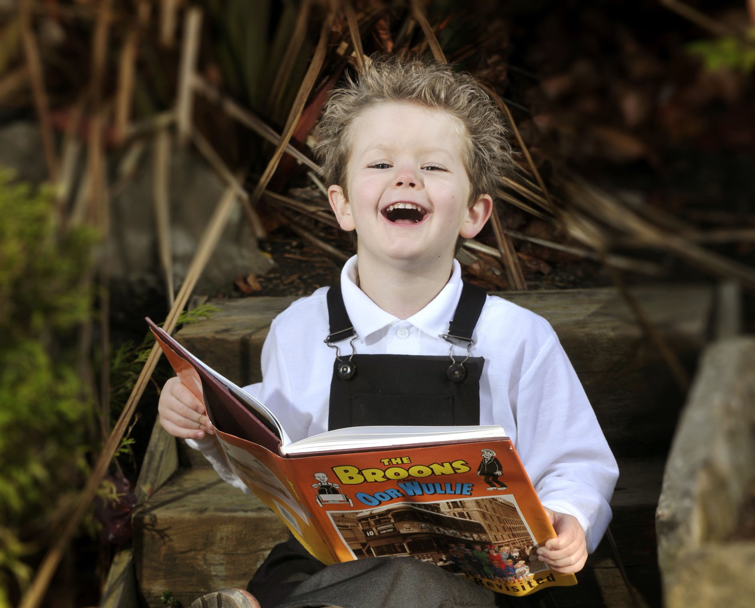 Image of child reading Ooor Wullie book