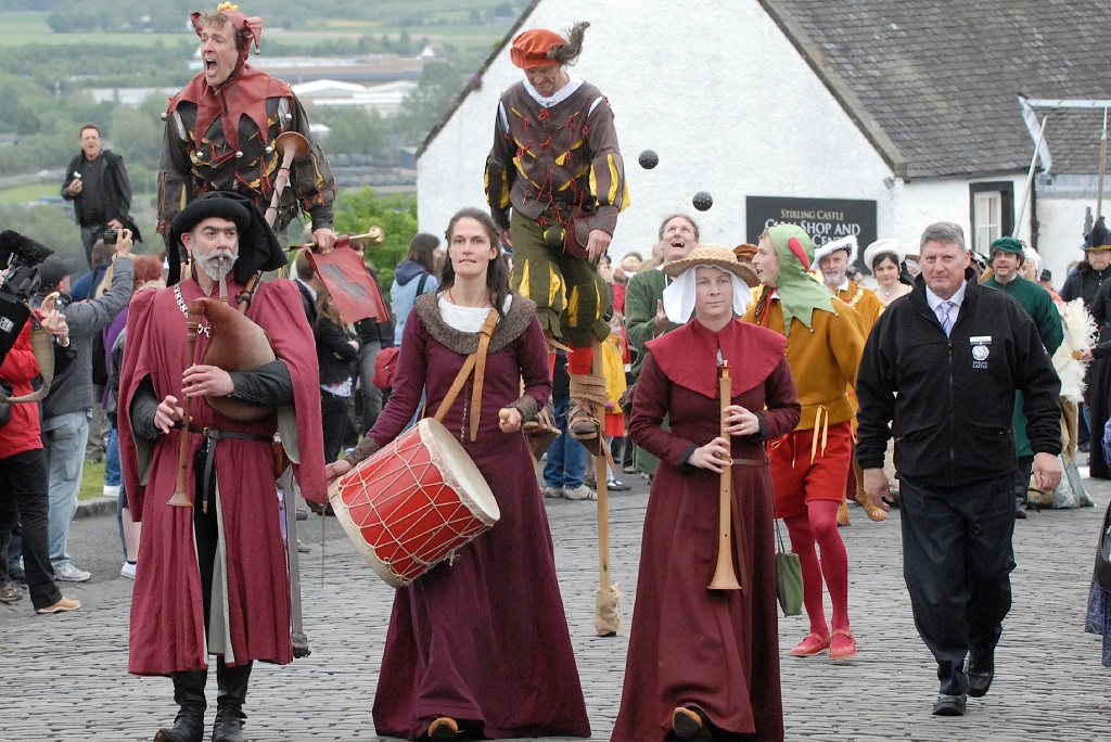 A parade of costumed performers on the Stirling Castle esplanade