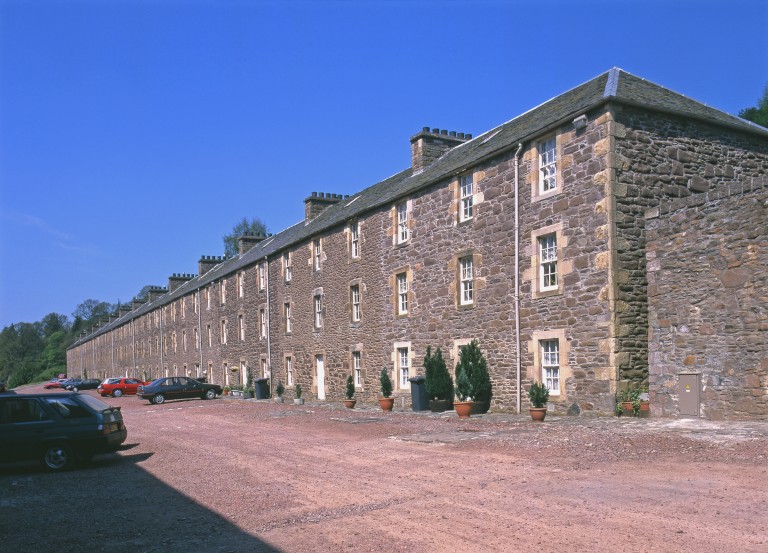 A photograph of a terraced building on a sunny day.