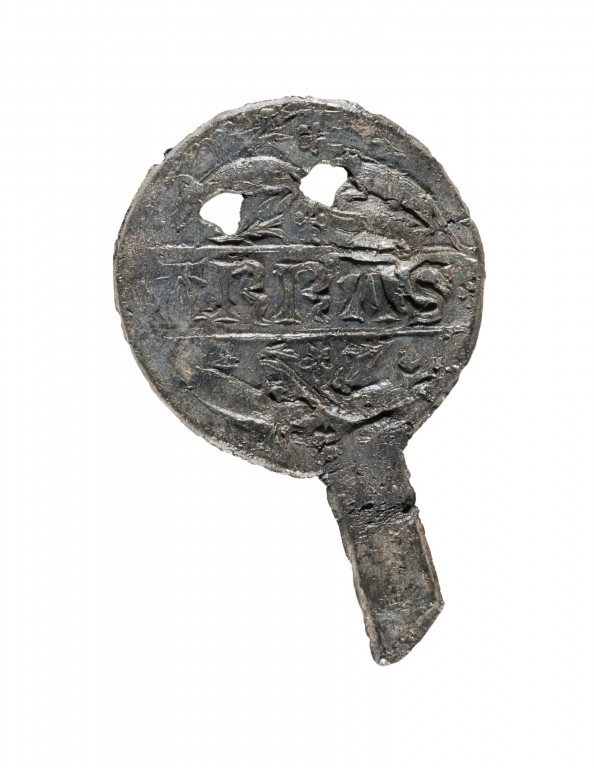 A photograph of a small metal artefact
