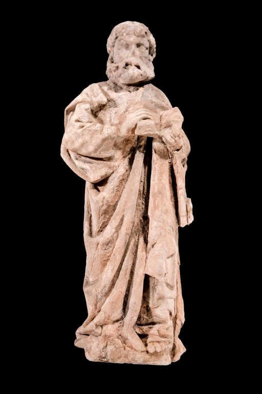 A photograph of a statue of a man with a beard, dressed in robes