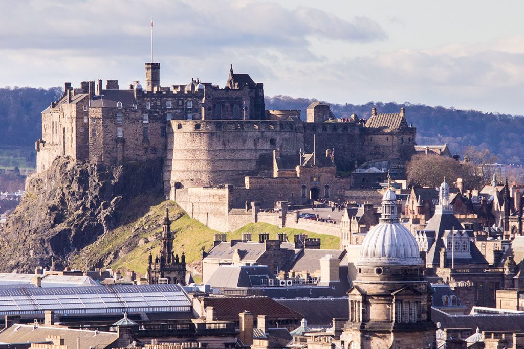 Image of a castle at the centre of a sunny cityscape 