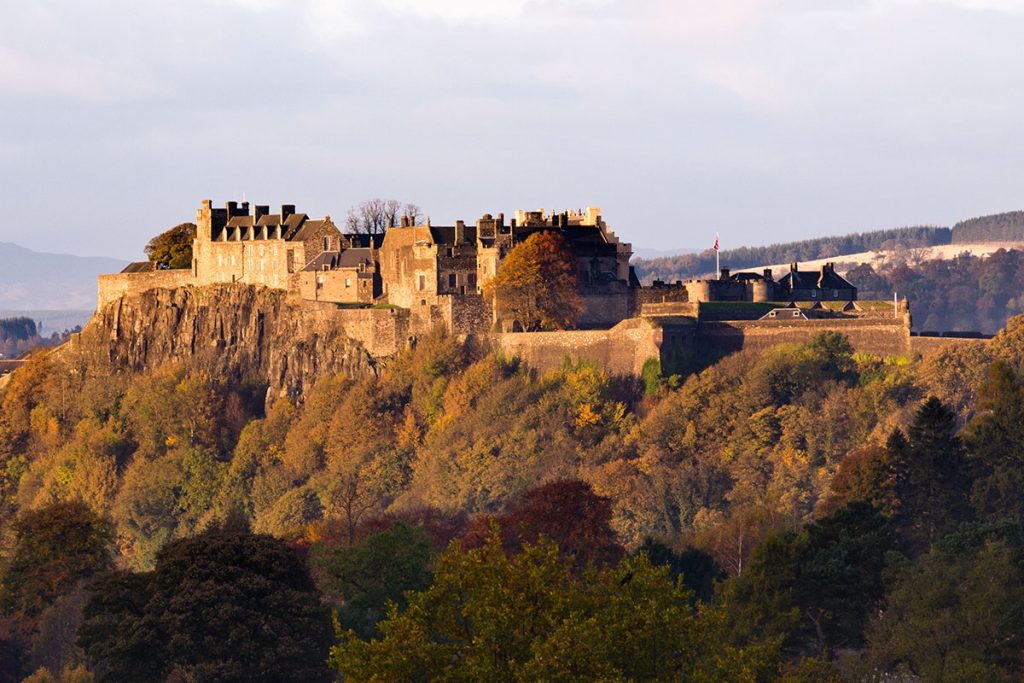 Image of a castle on a hill in the sunshine