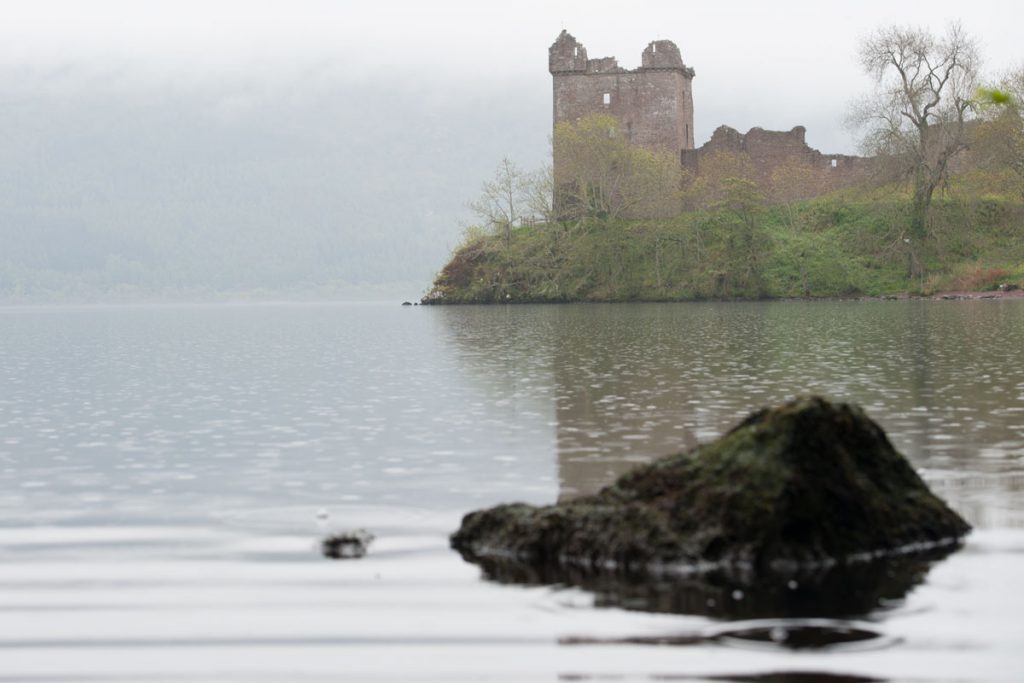 Image of castle ruins on the banks of a misty loch