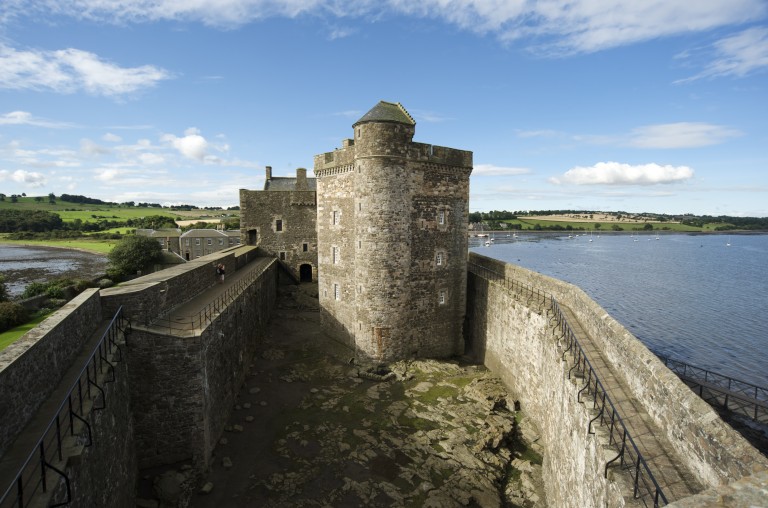 castle tower in a courtyard with walls on either side