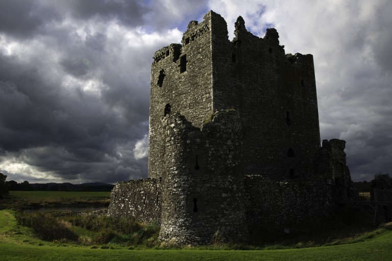 foreboding tower building with storm clouds in the sky above 