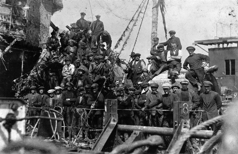 image of a shipwreck being raised with lots of men standing on deck