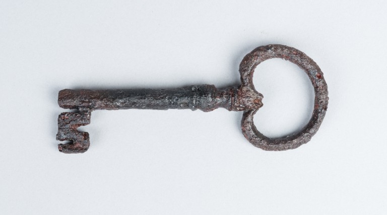 old key lying on a white background