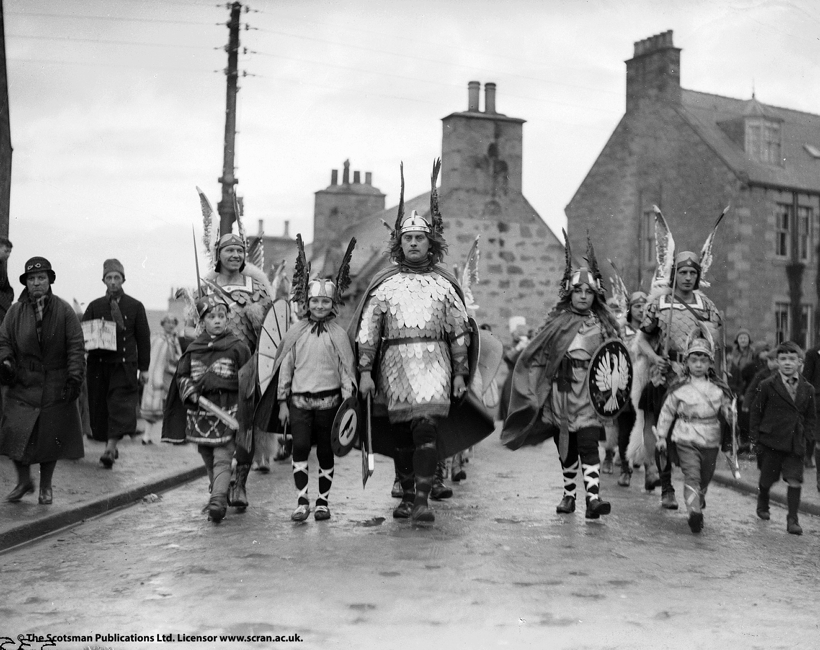 row of men in viking dress walk towards camera