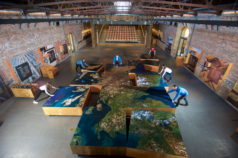 Image of a group of people assembling a large floor map of Scotland