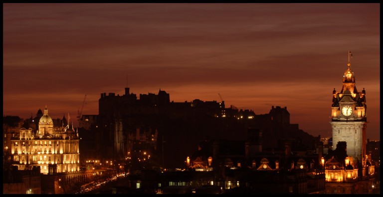 silhouette of castle against orange sky