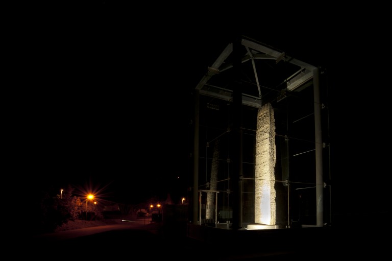 carved stone lit up at night