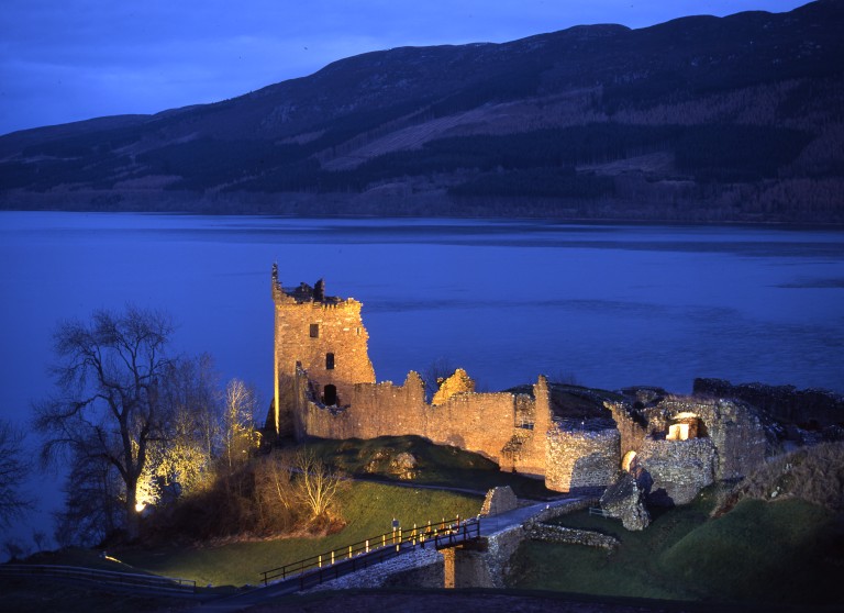 floodlit castle as dusk falls