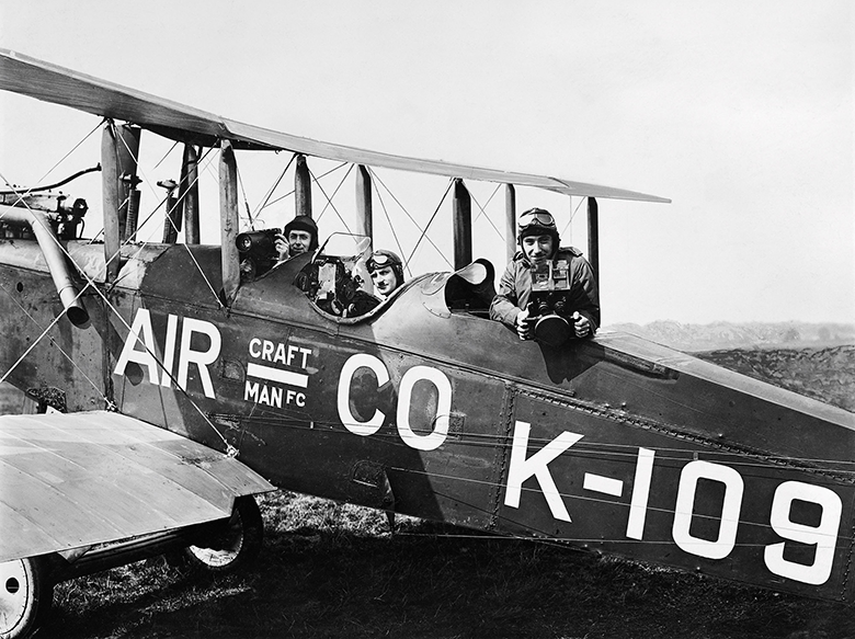 Photo showing young men in a biplane