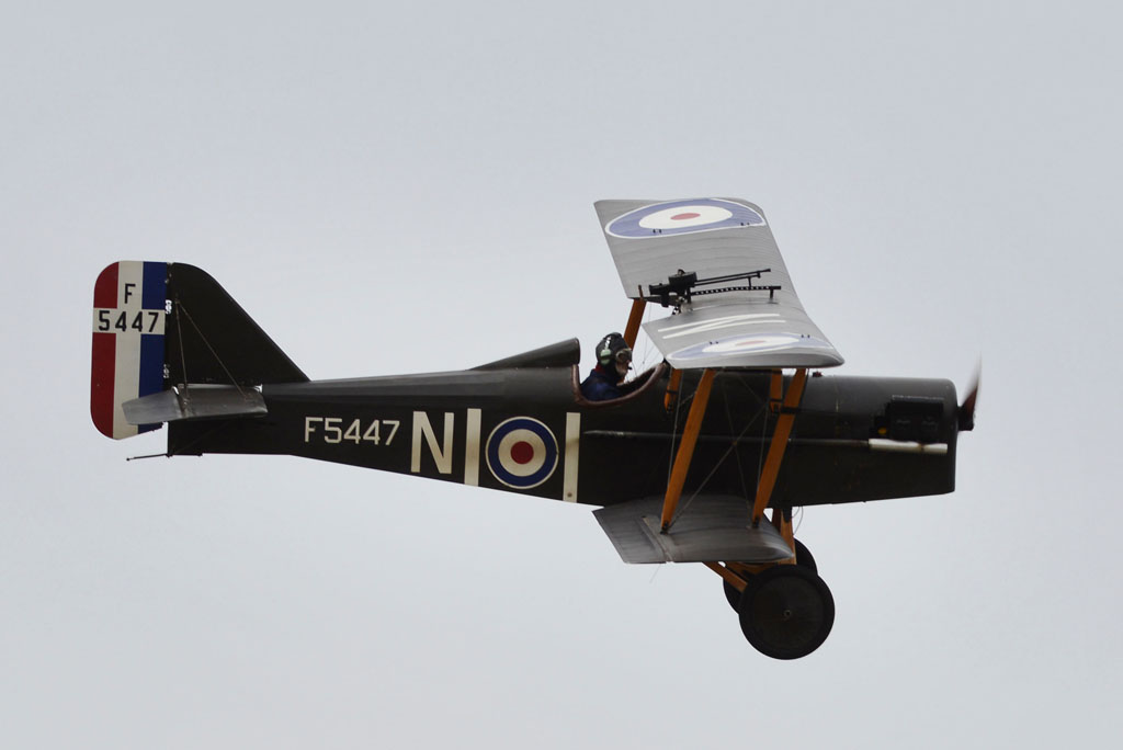 old fashioned airplane with propeller in flight