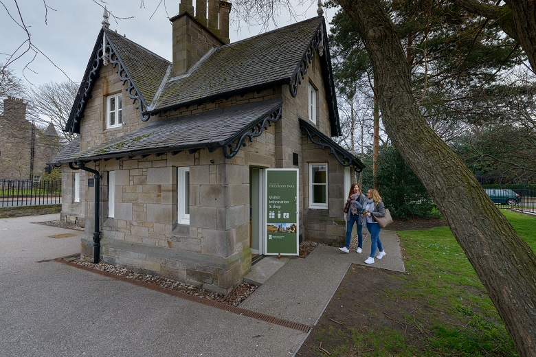 View of Holyrood Lodge with visitors arriving at the entrance