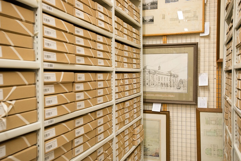 The store room at John Sinclair House. Neat boxes on shelves and stored paintings