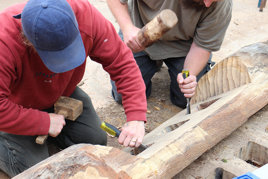 two people working with wood