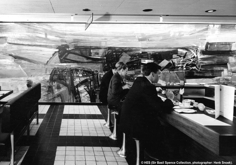 Visitors dine at Glasgow Airport's cafeteria with a large mural in the background