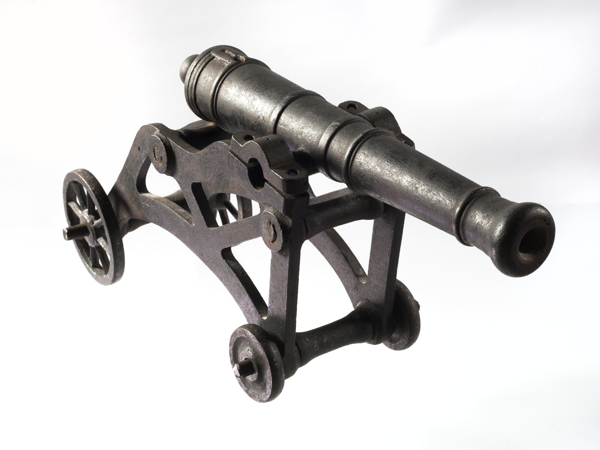 An intricate metal model of an old-fashioned cannon. 