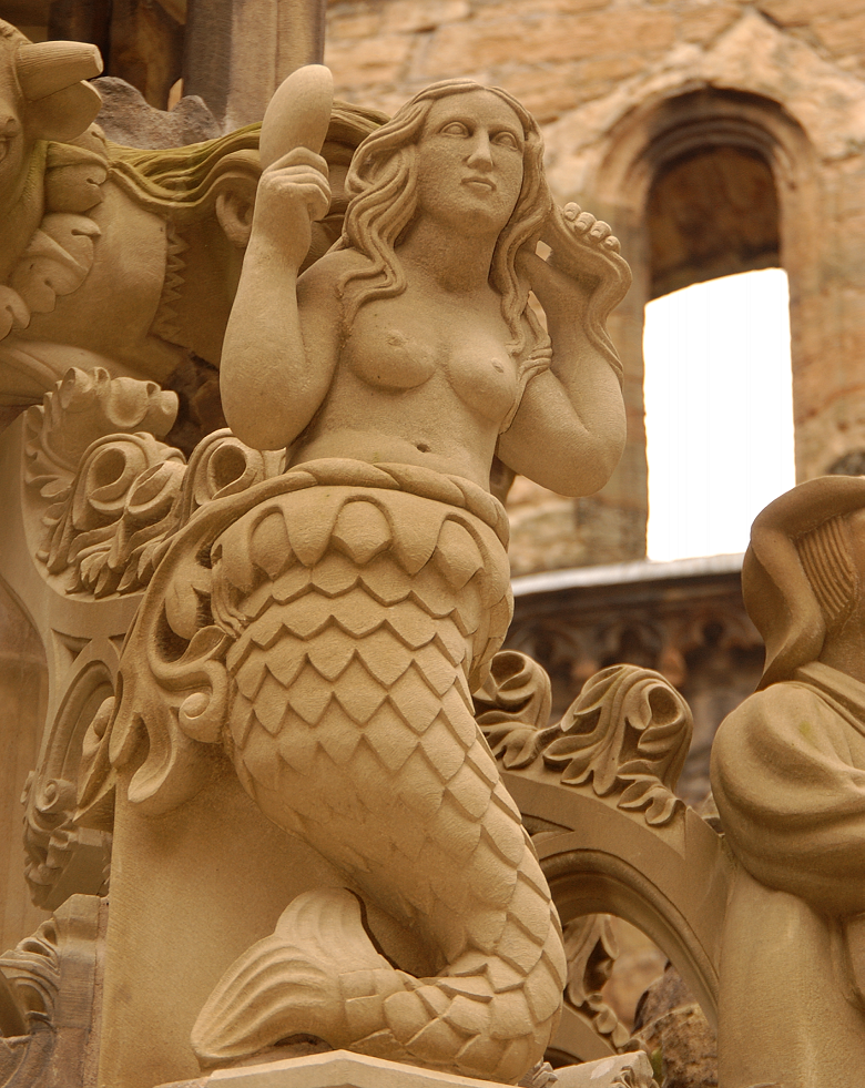 carving of a mermaid on the Linlithgow fountain. She looks in a mirror