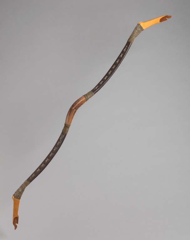 A replica Hamian bow. Made from wood, it has curved central handle. 