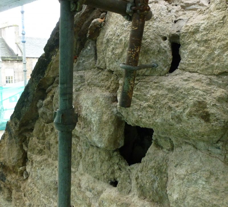 Damaged stonework with pipes