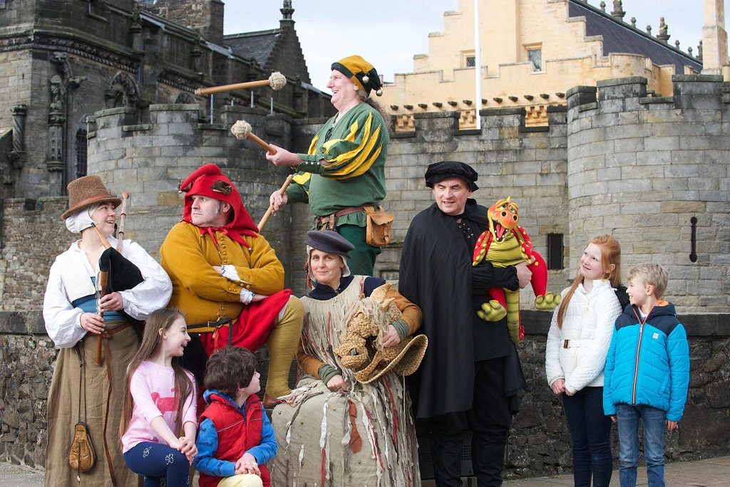 A group of costumed performers in front of Stirling Castle