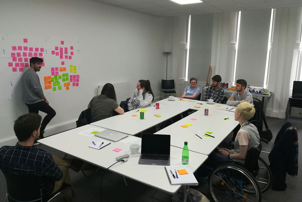 Image of a group of young people participating in an ideas workshop