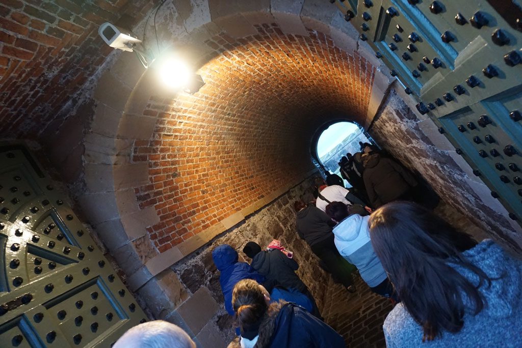 Image of a group of young people walking through the arched entrance of Fort George on Care Day