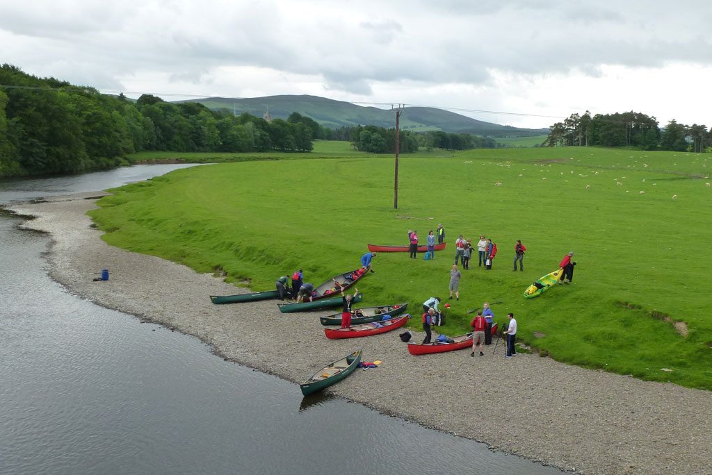 Image of a group of researchers undertaking a canoe trip down the river Clyde