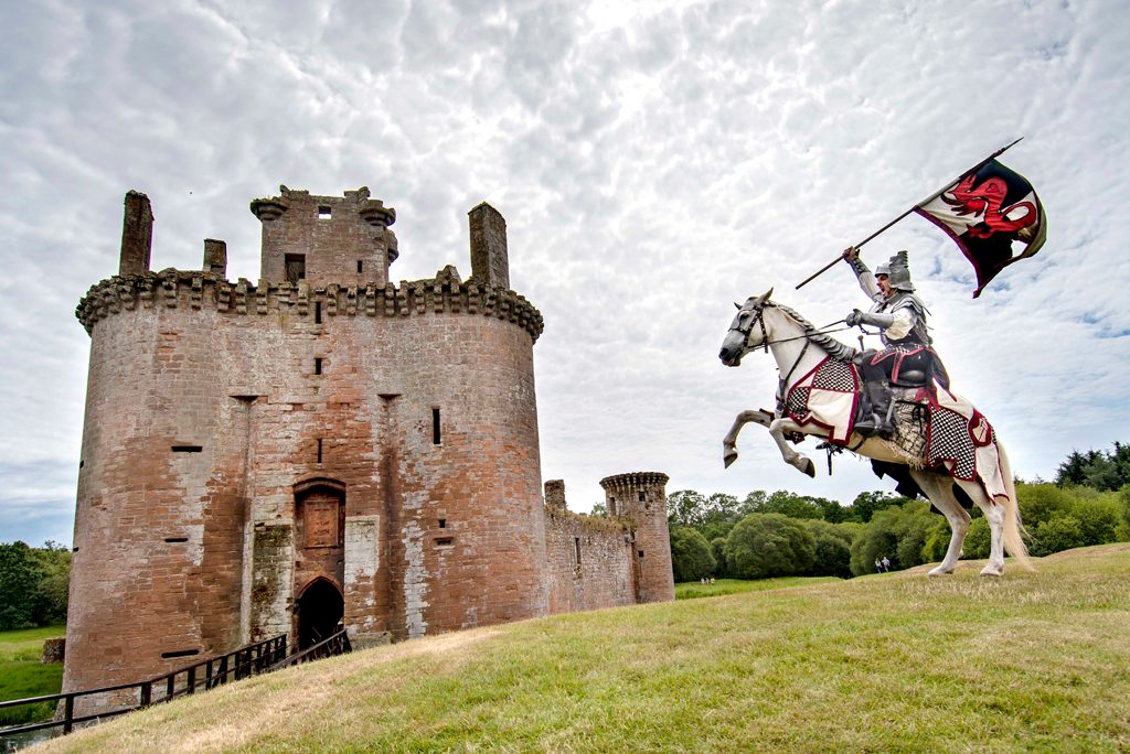 knight on horseback beside castle
