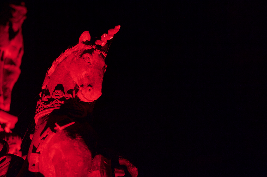 The stone unicorn from Linlithgow Palace fountain bathed in red light