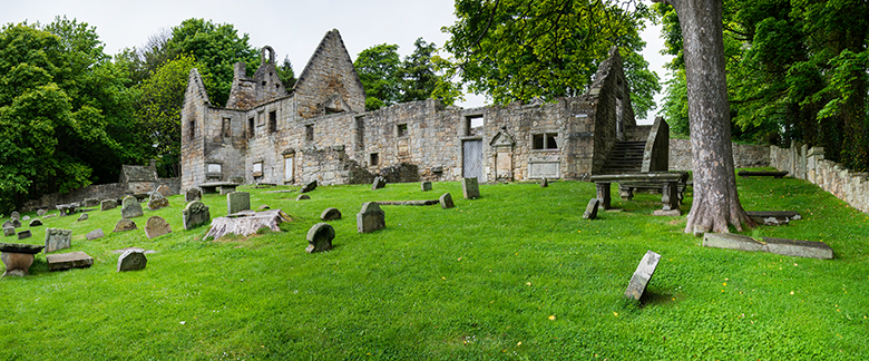 View across a graveyard to a ruined church