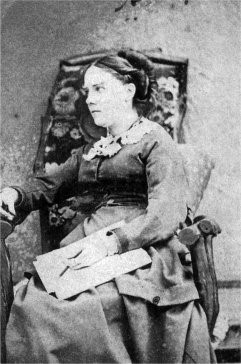 A photograph of a lady in a chair 