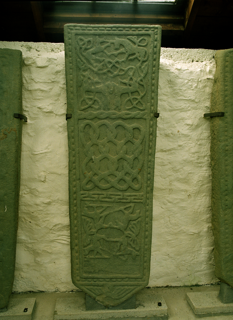 View of a grave slab which features a medieval carving of entertwined animals, including a unicorn