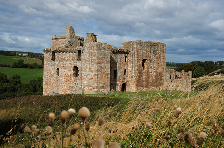 exterior of Crichton Castle in a remote location with wild grass in the foreground