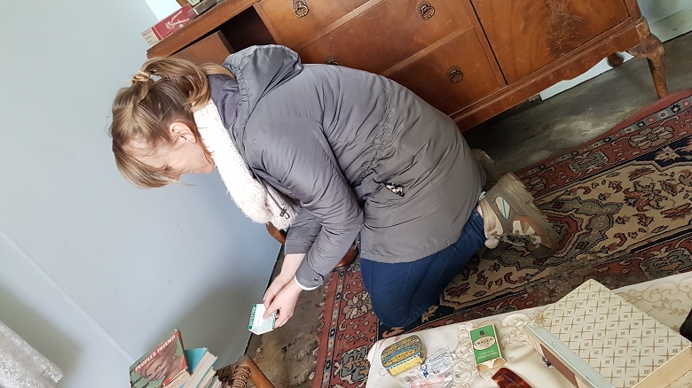 A slef-confessed insect geek kneels on the carpet in a traditional cottage setting a bug trap