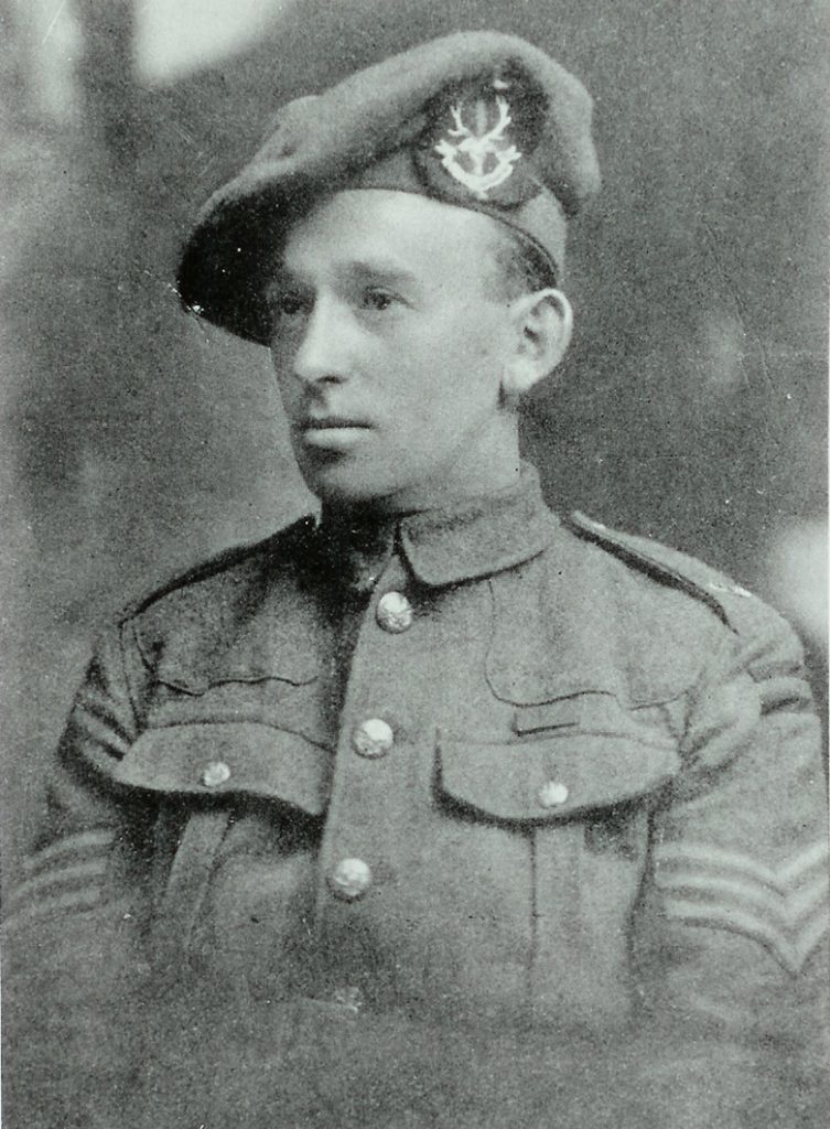 Head and shoulders portrait of a clean-shaven man in military uniform.