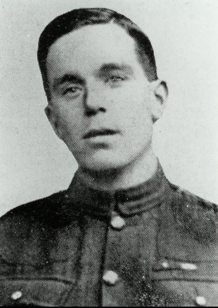 Head and shoulders portrait of a man in military uniform. He's clean-shaven and not wearing a hat.